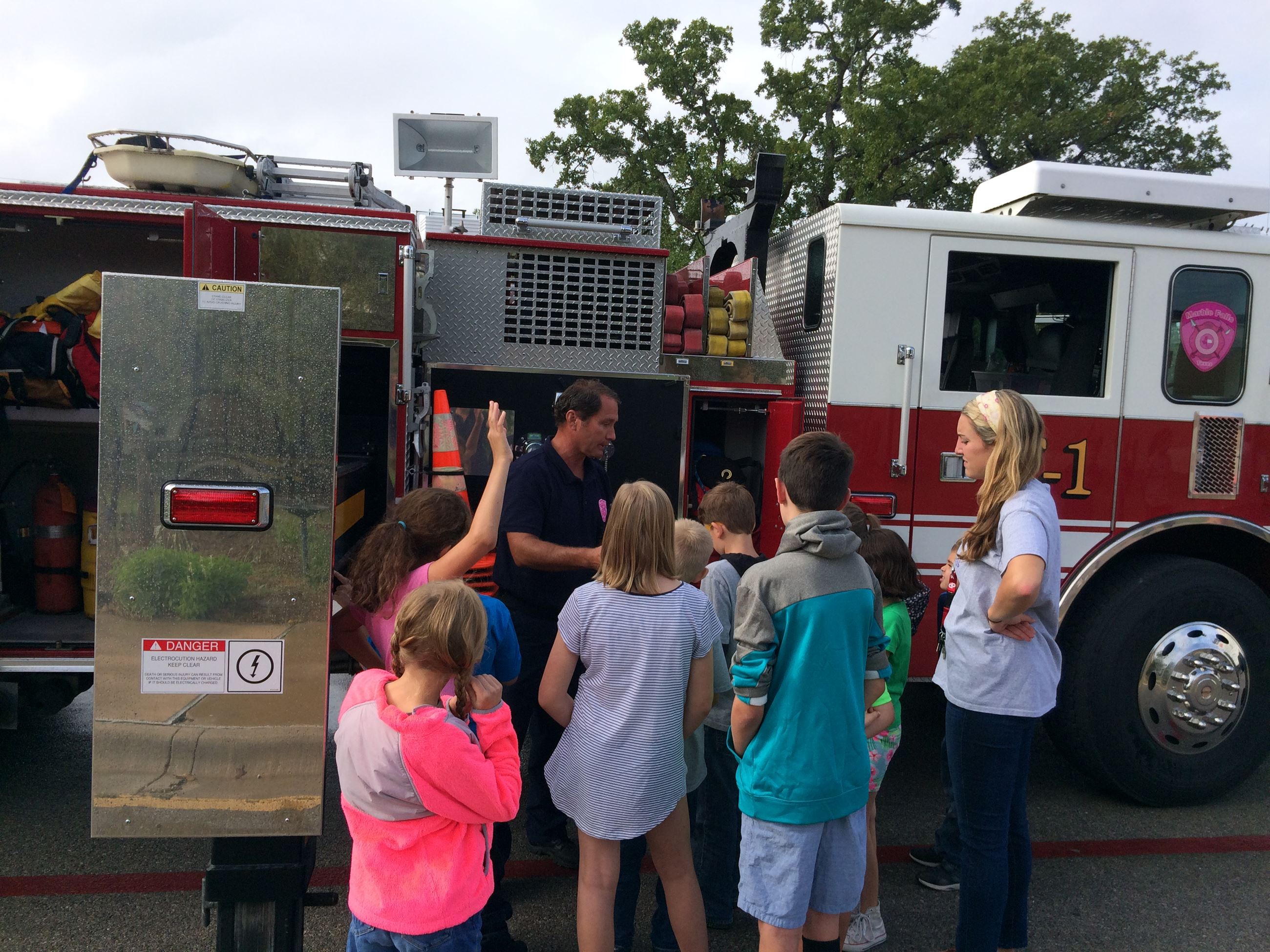 Children gather next to a fire truck