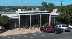 city hall building with a truck parked in front